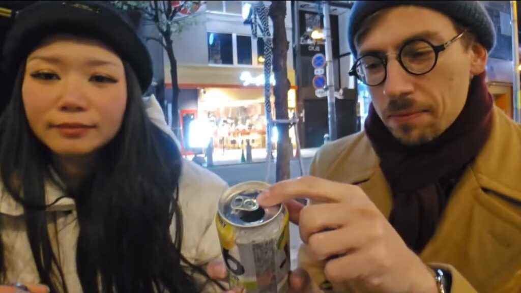 Harry McFann showing his technique to twist the can's tab at a different angle after opening it so he doesn't mistake someone else's can for his.